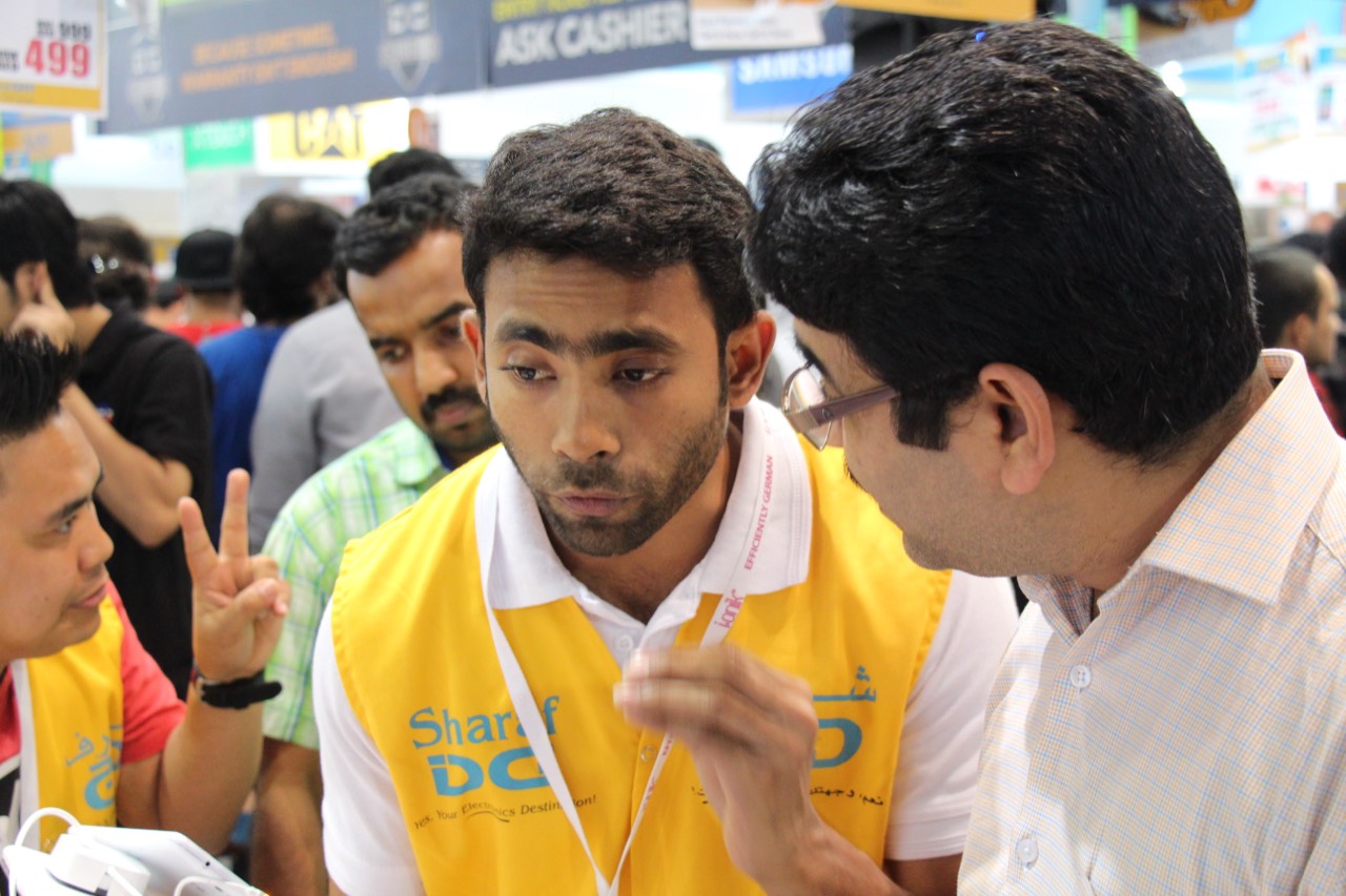Sharaf DG in-store brand promoter helping a customer